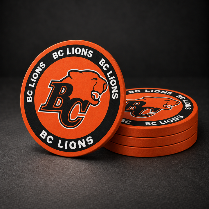 BC Lions Drink Coasters with orange sides, three stacked and one standing on a dark charcoal background