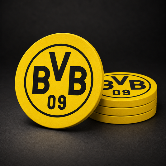Borussia Dortmund Drink Coasters with yellow sides, three stacked and one standing on a dark charcoal background