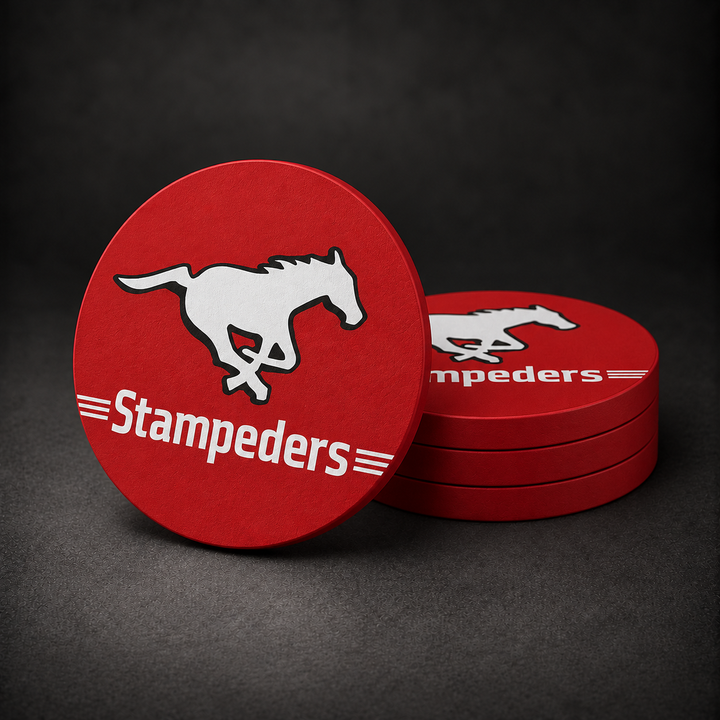 Calgary Stampeders Drink Coasters with red sides, three stacked and one standing on a dark charcoal background
