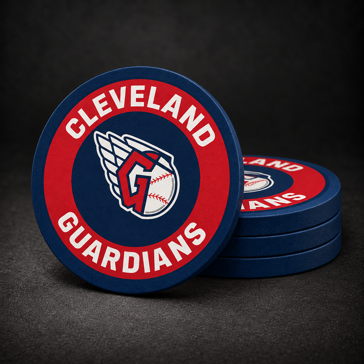 Cleveland Guardians Drink Coasters with navy blue sides, three stacked and one standing on a dark charcoal background