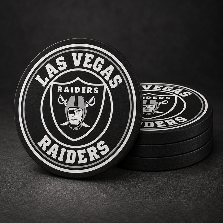 Las Vegas Raiders Drink Coasters with black sides, three stacked and one standing on a dark charcoal background