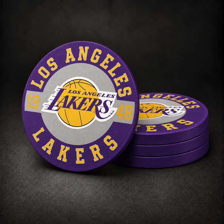 Los Angeles Lakers Drink Coasters with purple sides, three stacked and one standing on a dark charcoal background