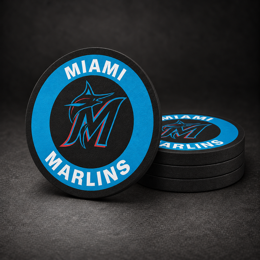 Miami Marlins Drink Coasters with black sides, three stacked and one standing on a dark charcoal background