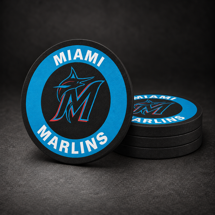 Miami Marlins Drink Coasters with black sides, three stacked and one standing on a dark charcoal background