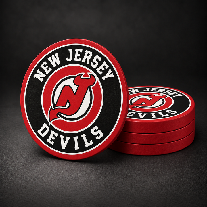 New Jersey Devils Drink Coasters with red sides, three stacked and one standing on a dark charcoal background