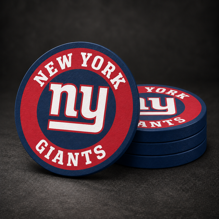 New York Giants Drink Coasters with navy blue sides, three stacked and one standing on a dark charcoal background