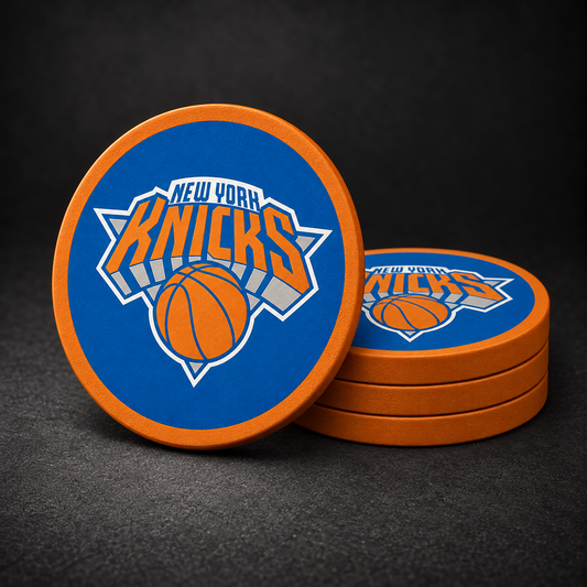 New York Knicks Drink Coasters with orange sides, three stacked and one standing on a dark charcoal background