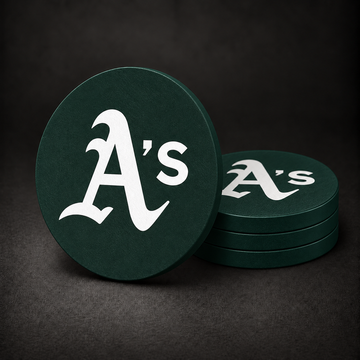Oakland Athletics Drink Coasters with dark green sides, three stacked and one standing on a dark charcoal background
