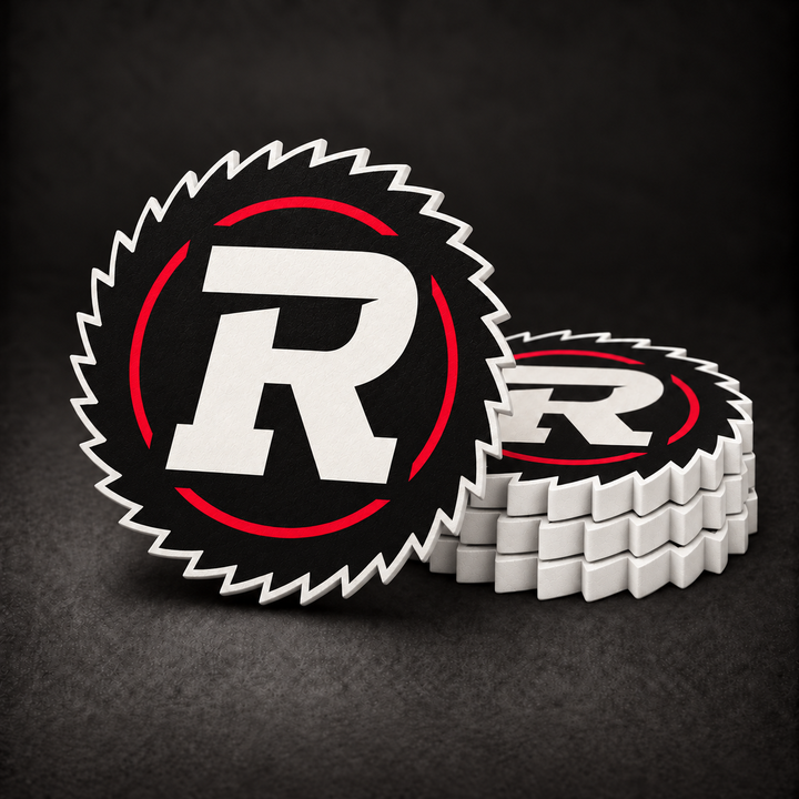 Ottawa Redblacks buzzsaw-shaped drink coasters with black faces, white toothed edges and sides, three stacked and one standing on a dark charcoal background