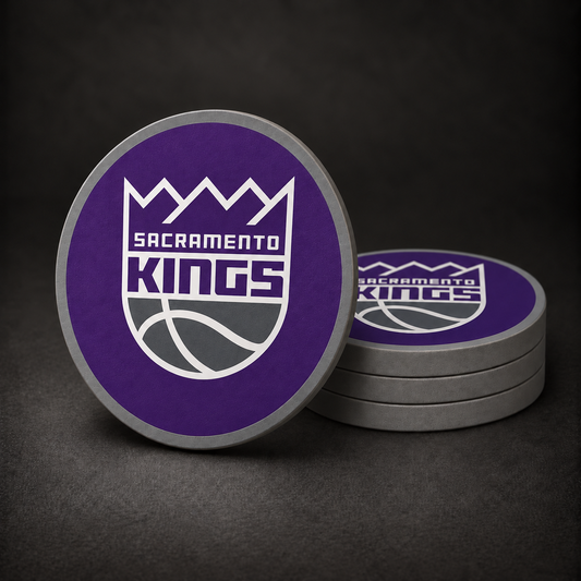 Sacramento Kings drink coasters with centred shield logo, purple faces and grey sides, three stacked and one standing on charcoal background