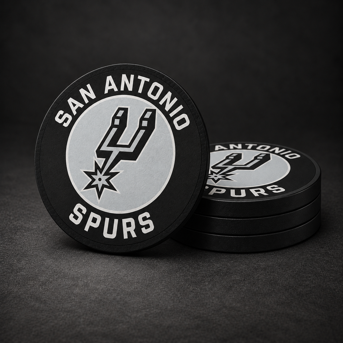 San Antonio Spurs Drink Coasters with black sides, three stacked and one standing on a dark charcoal background