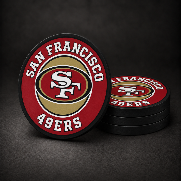 San Francisco 49ers Drink Coasters with black sides, three stacked and one standing on a dark charcoal background