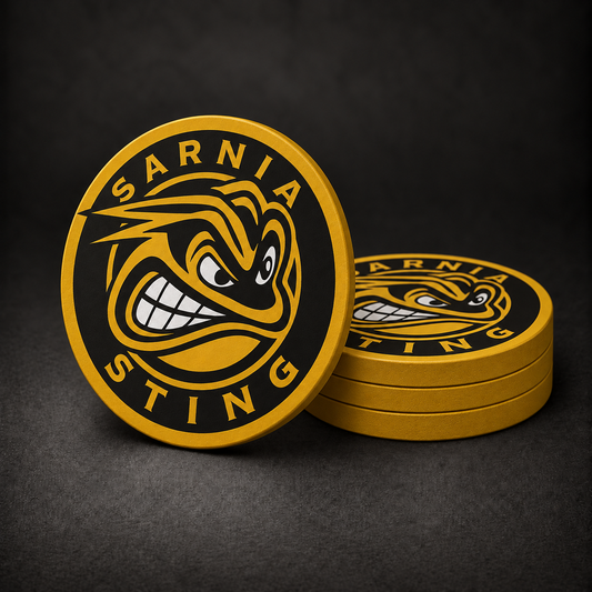 Sarnia Sting Drink Coasters with gold sides, three stacked and one standing on a dark charcoal background