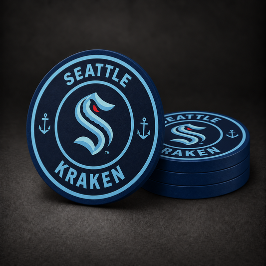 Seattle Kraken Drink Coasters with navy blue sides, three stacked and one standing on a dark charcoal background