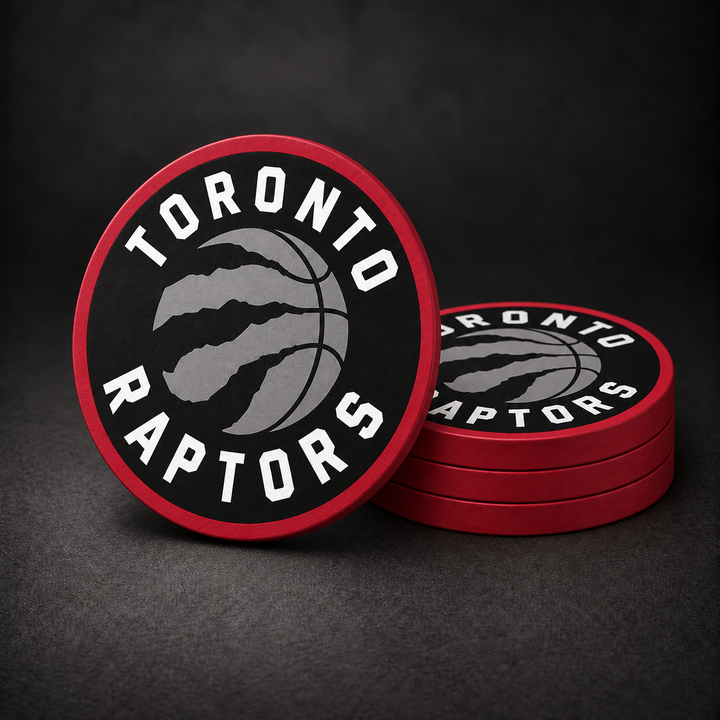 Toronto Raptors Drink Coasters with red sides, three stacked and one standing on a dark charcoal background