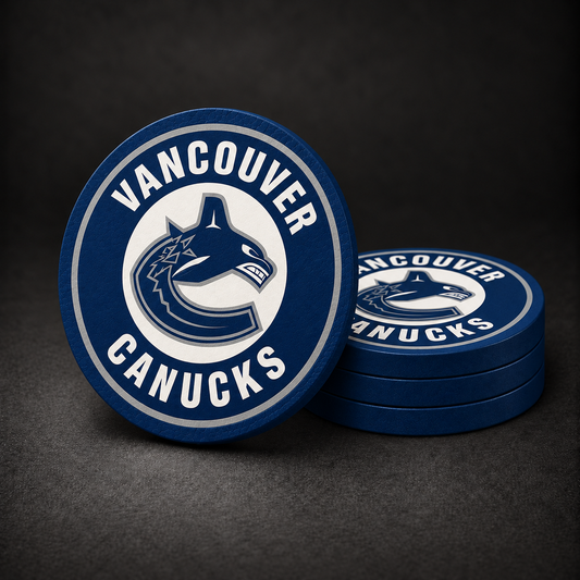 Vancouver Canucks Drink Coasters with navy blue sides, three stacked and one standing on a dark charcoal background