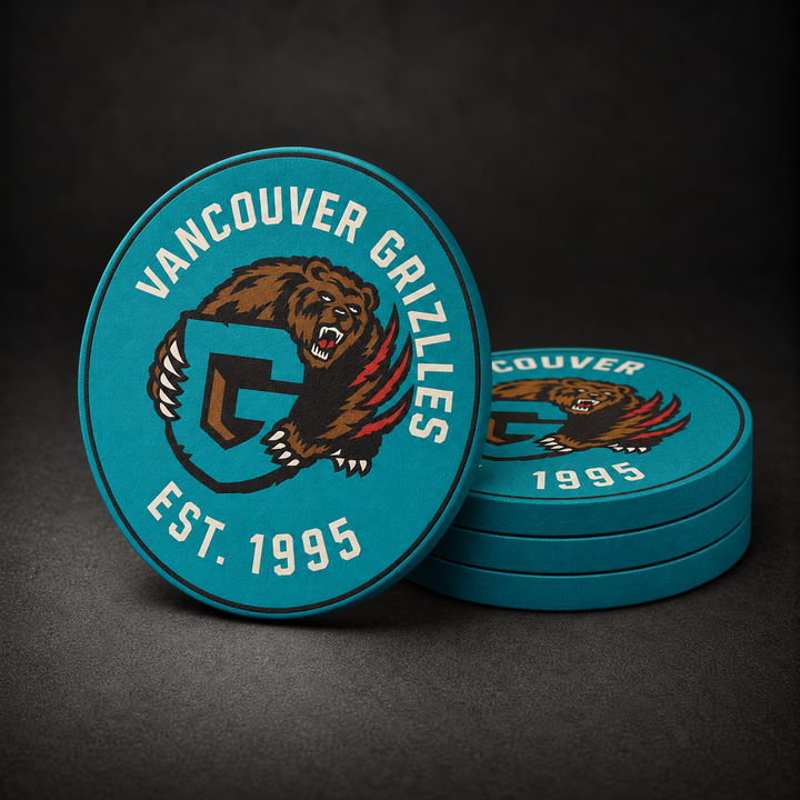 Vancouver Grizzlies Drink Coasters with teal sides, three stacked and one standing on a dark charcoal background