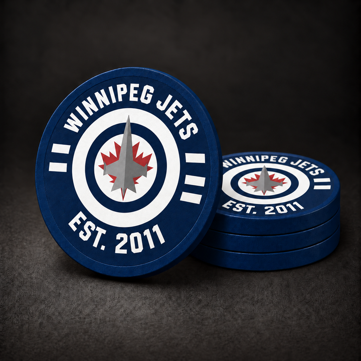 Winnipeg Jets Drink Coasters with navy blue edges and sides, three stacked and one standing on a charcoal background; white lettering and stripes